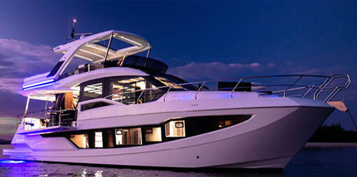 Motor Yacht Starting Over night photo shot side profile image anchored in the Bahamas